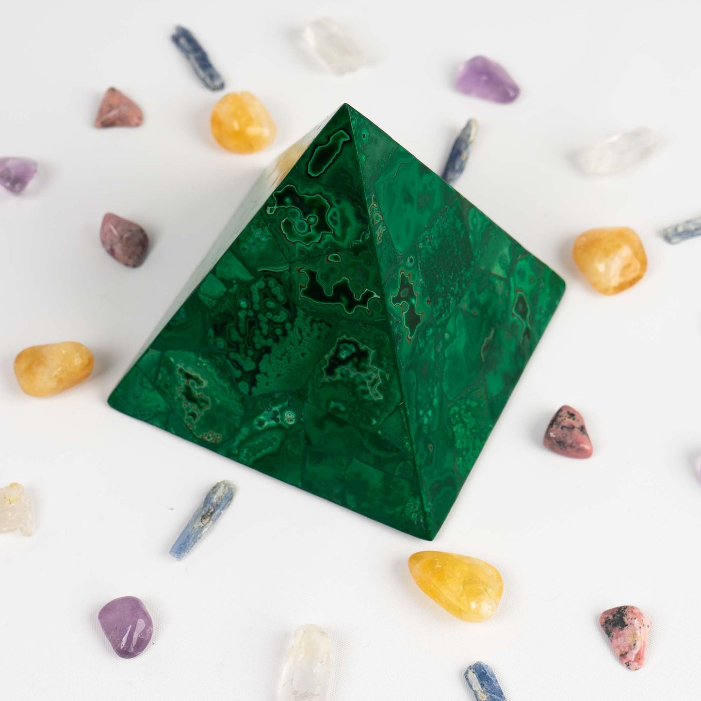 green malachite pyramid sculpture in a prosperity crystal grid