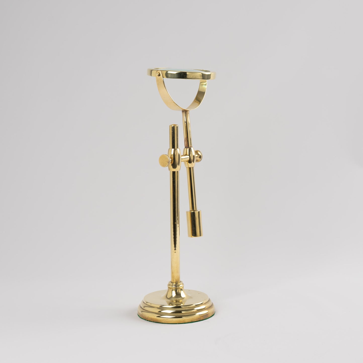 Vintage brass magnifying glass with adjustable stand by Sarreid, featuring brass finish and clear magnifying lens, marked Made in Korea