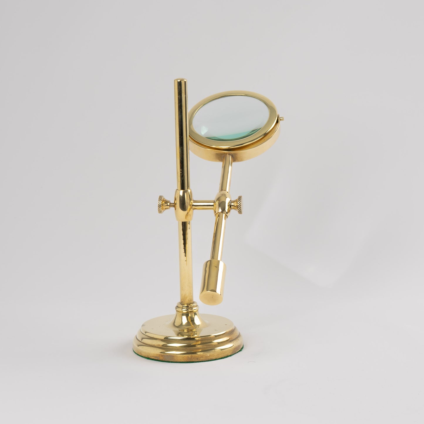Vintage brass magnifying glass with adjustable stand by Sarreid, featuring brass finish and clear magnifying lens, marked Made in Korea