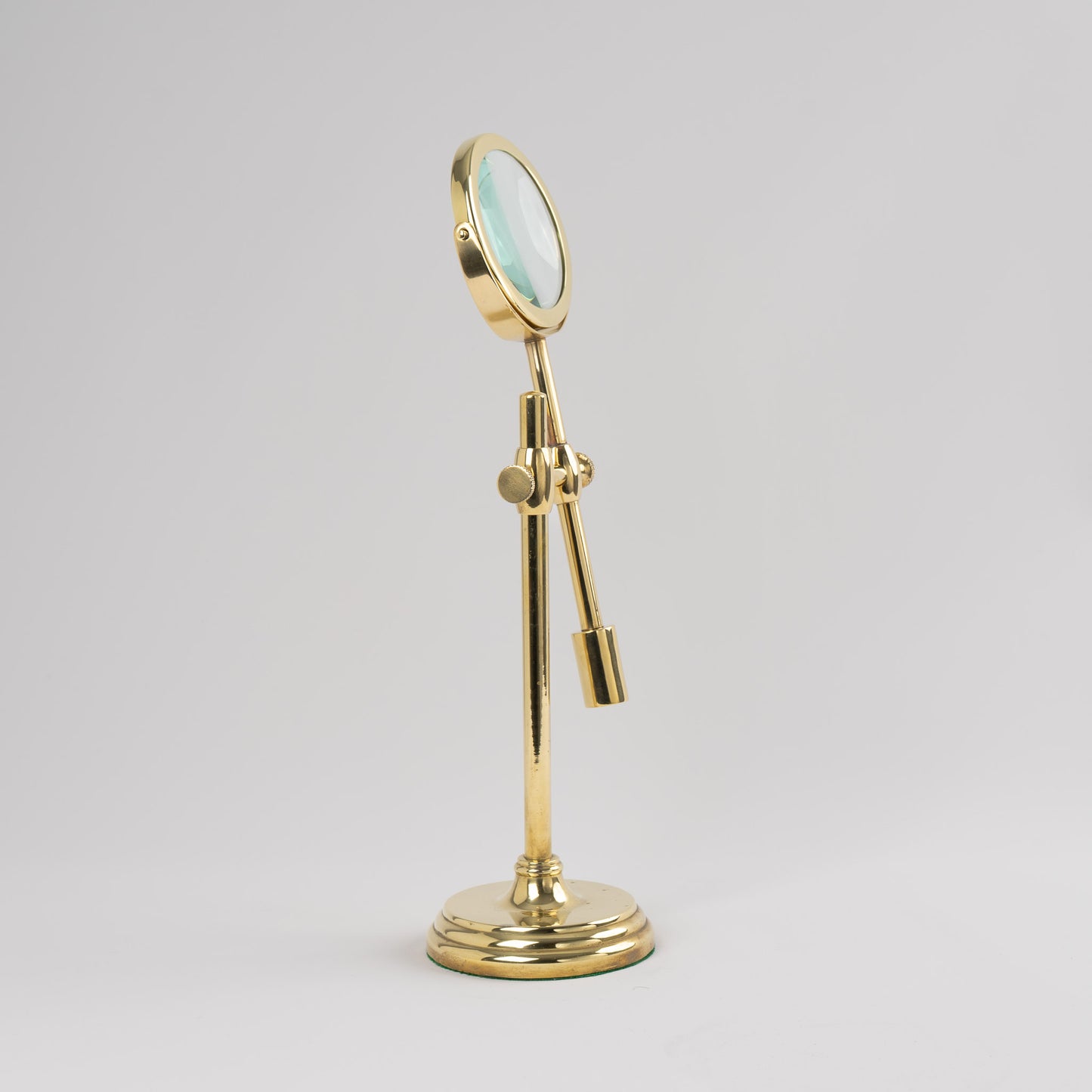 Vintage brass magnifying glass with adjustable stand by Sarreid, featuring brass finish and clear magnifying lens, marked Made in Korea