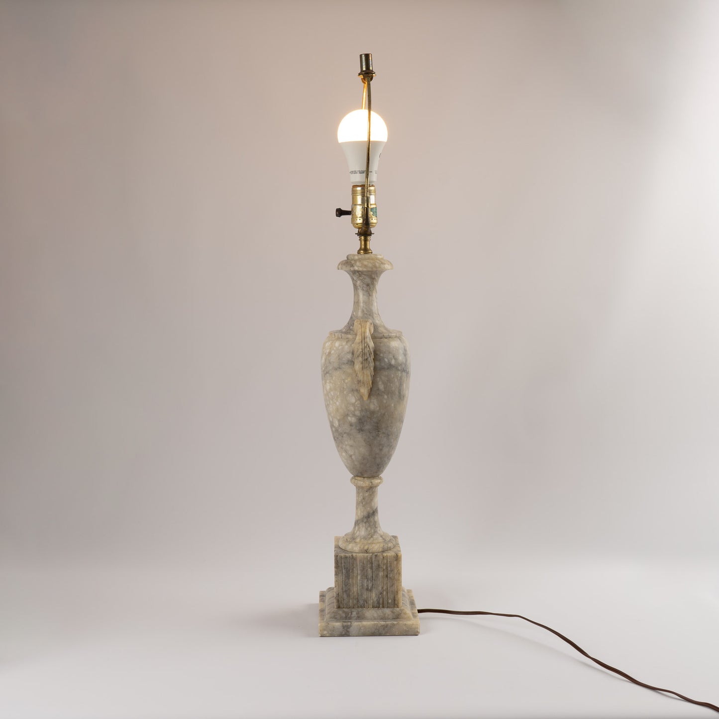 Vintage 1950s neoclassical marble table lamp with urn shape, side handles, and tiered square base 