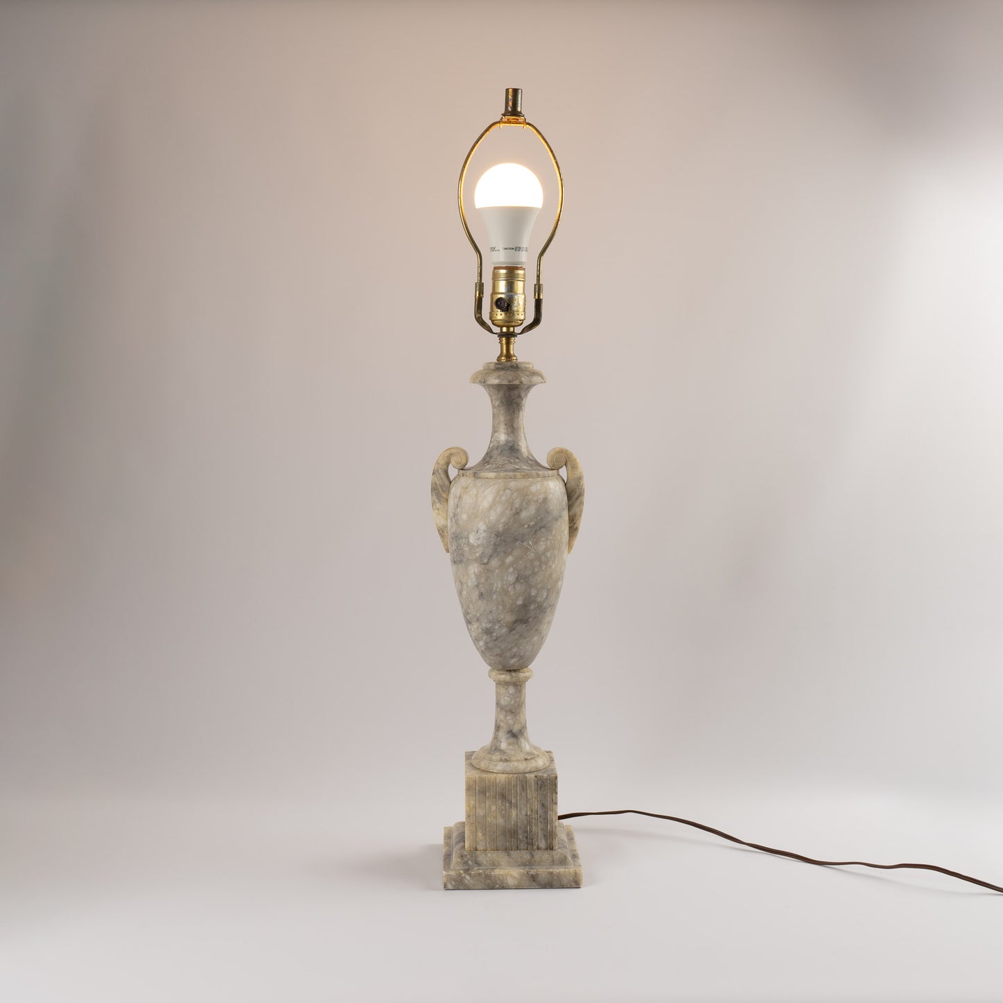 Vintage 1950s neoclassical marble table lamp with urn shape, side handles, and tiered square base 