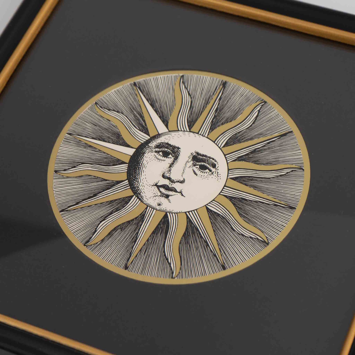 Vintage Piero Fornasetti Sole VI framed etching showing stylized sun face design in black frame with gold accent and black mat, from the famous Soli e Lune series