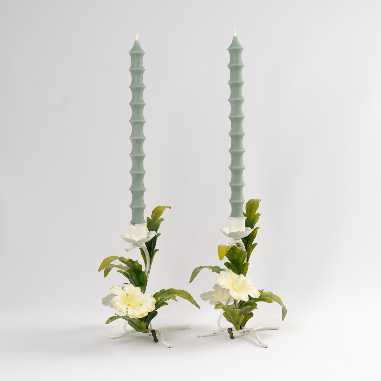 Midcentury 1960s Italian tole metal candlestick holders with hand-painted white and yellow floral design and green leaves
