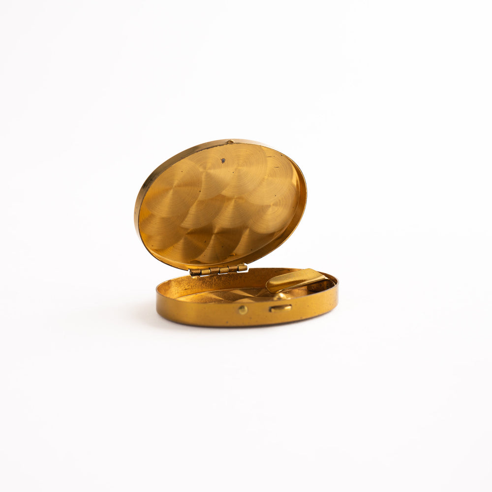 
                  
                    vintage oval brass pocket ashtray with painted cigarette design
                  
                