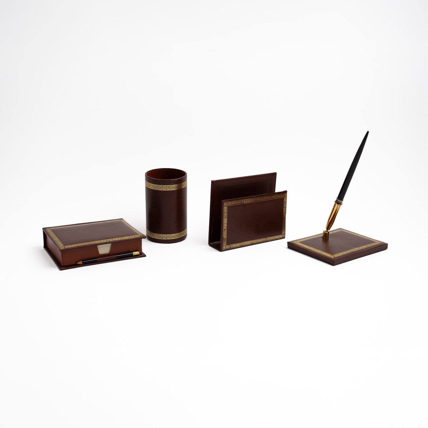 A dark brown leather desk organizer set with gold Greek key trim