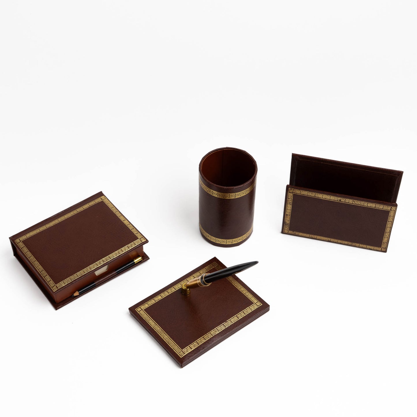 Vintage brown leather desk set with gold Greek key trim, showing all four pieces arranged together.
