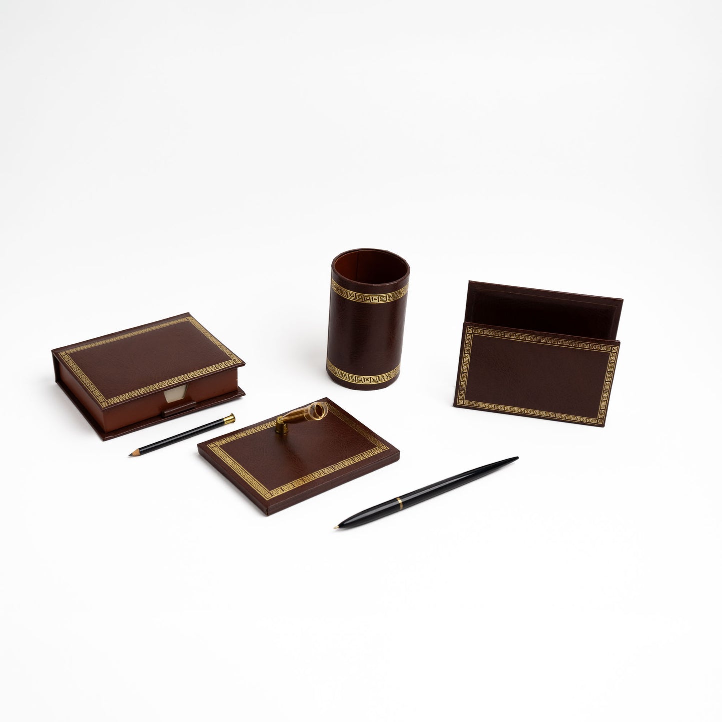 Vintage brown leather desk set with gold Greek key trim, showing all four pieces arranged together.