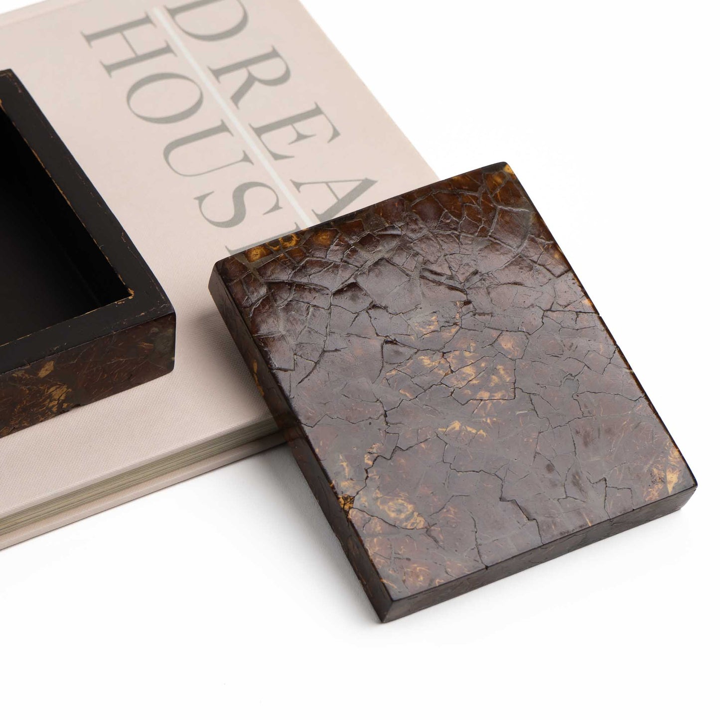 Tessellated coconut shell box styled as decor on a vintage coffee table book