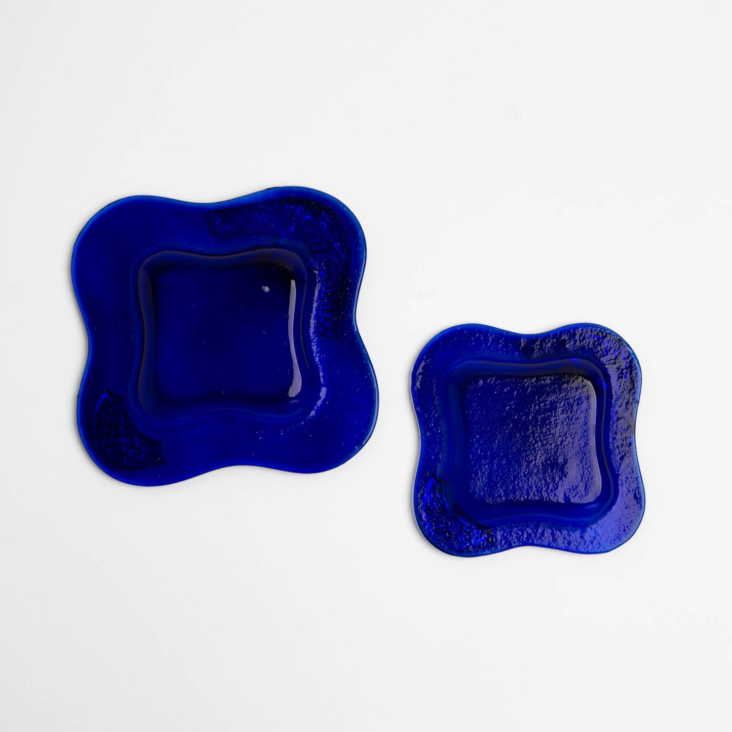 Set of two vintage cobalt blue square glass catchalls with silver-plated floral rose overlay design bottom view