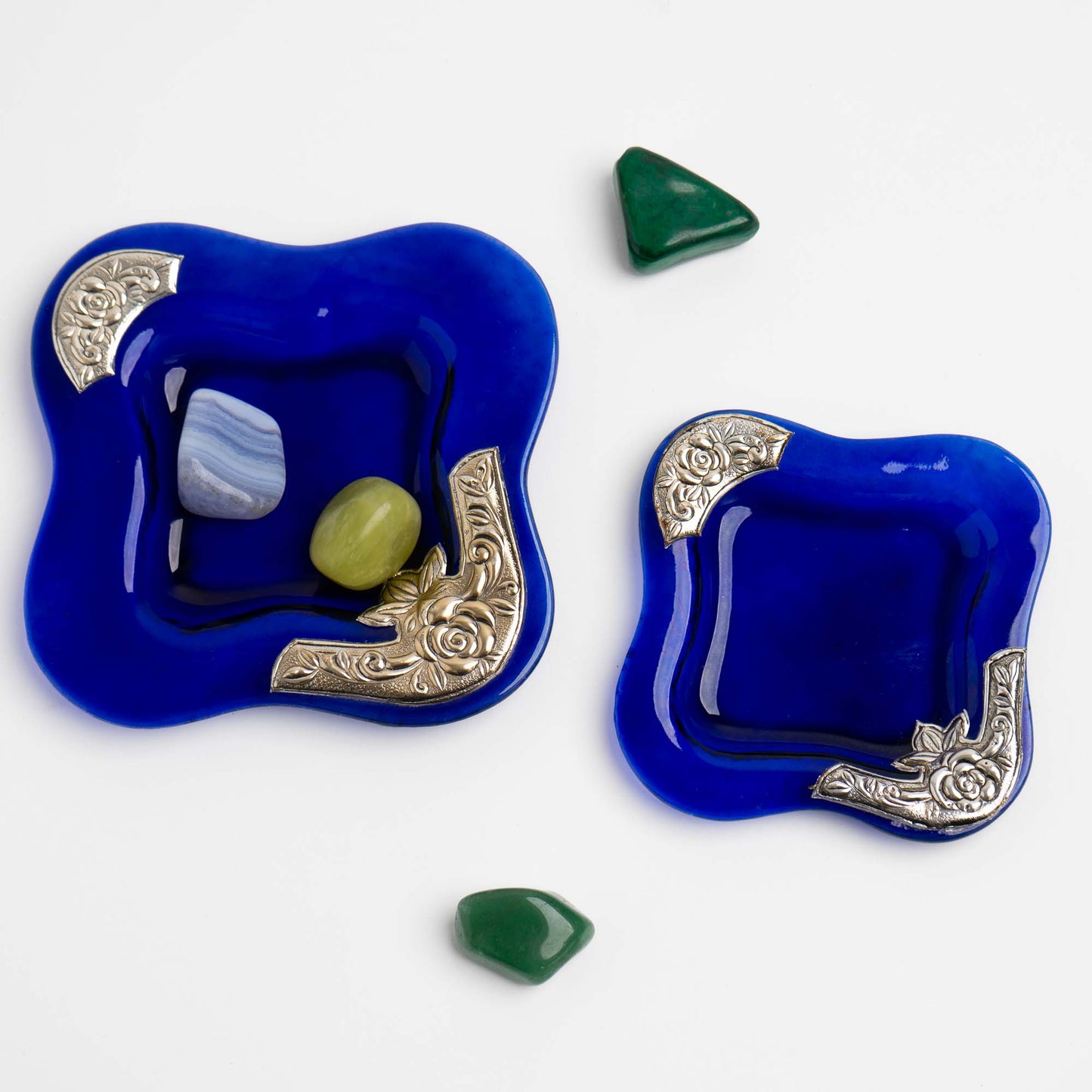 Set of two vintage cobalt blue square glass catchalls with silver-plated floral rose overlay design , shown holding colorful crystals 