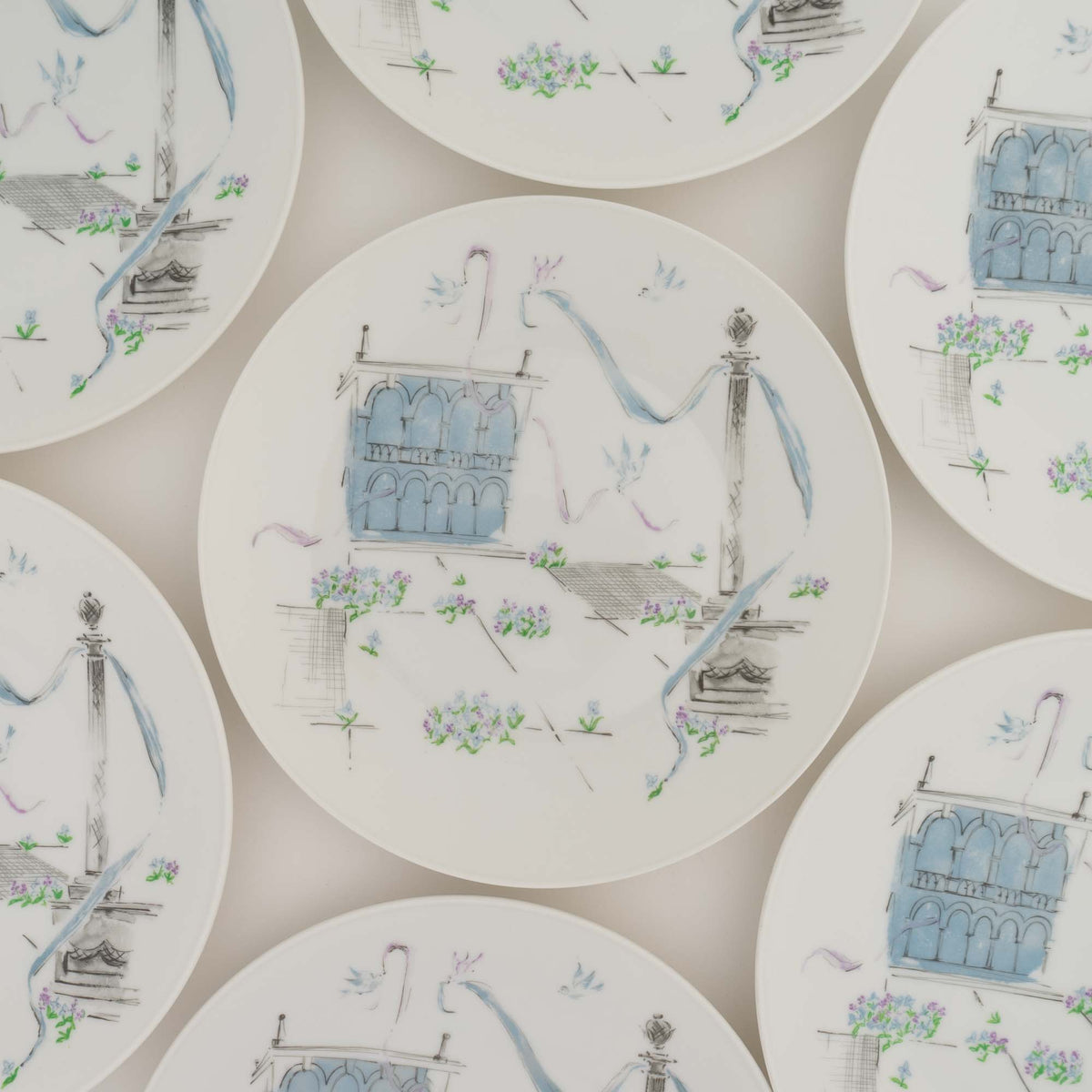 Close-up of sketchy blue ribbons and purple flowers on a Rosenthal Plaza porcelain plate