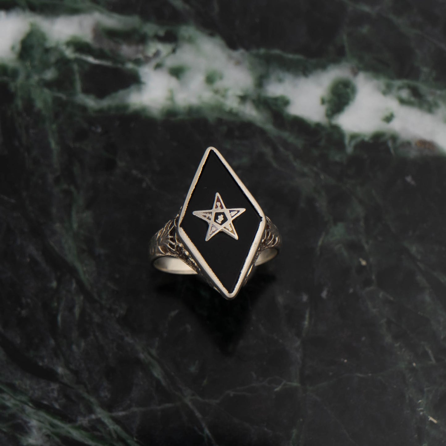 Vintage 14k white gold masonic ring with black onyx stone featuring Eastern Star symbol inlay, showing Art Nouveau decorative details on band sides