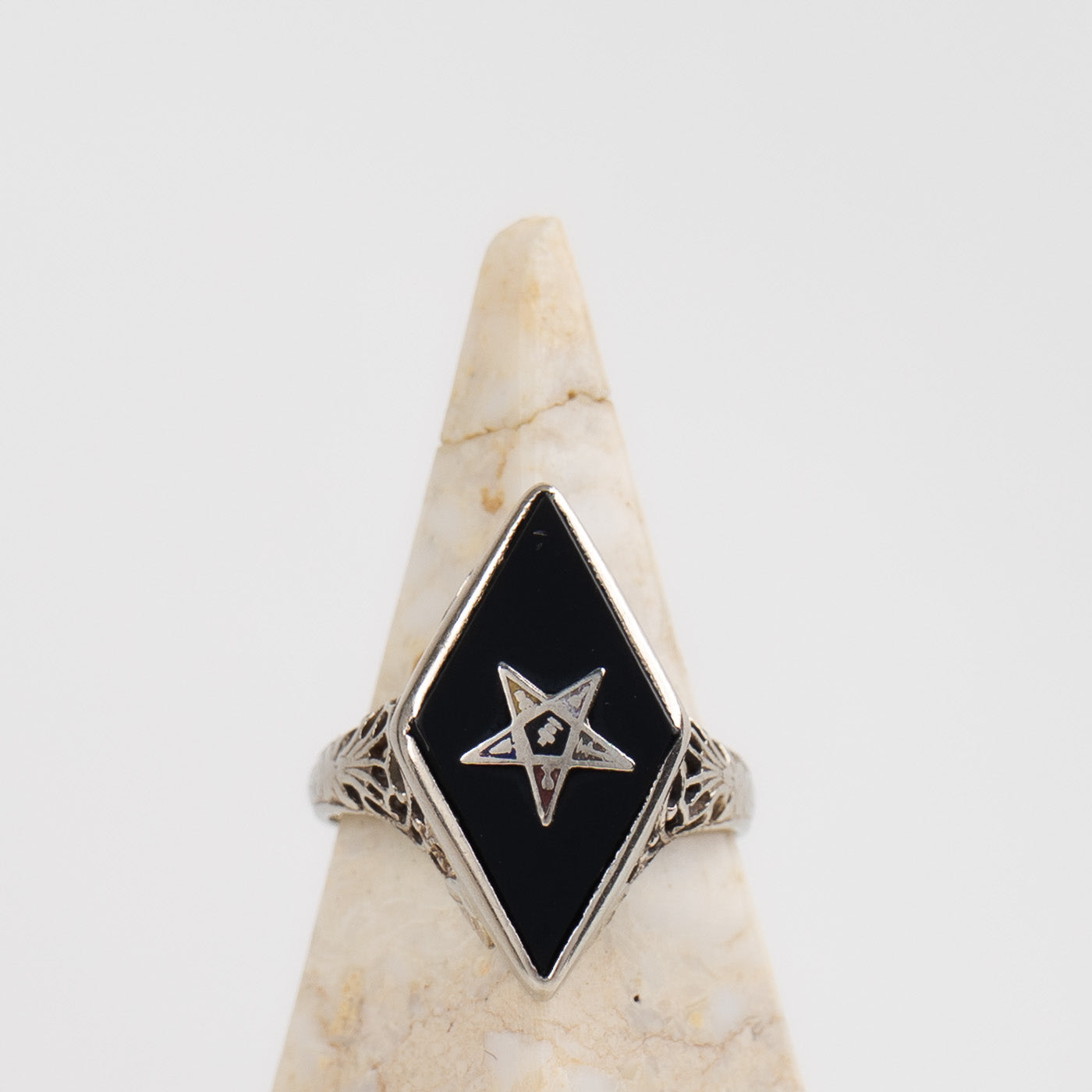 Vintage 14k white gold masonic ring with black onyx stone featuring Eastern Star symbol inlay, showing Art Nouveau decorative details on band sides
