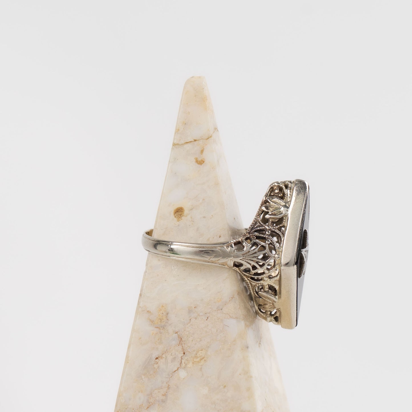 Vintage 14k white gold masonic ring with black onyx stone featuring Eastern Star symbol inlay, showing Art Nouveau decorative details on band sides