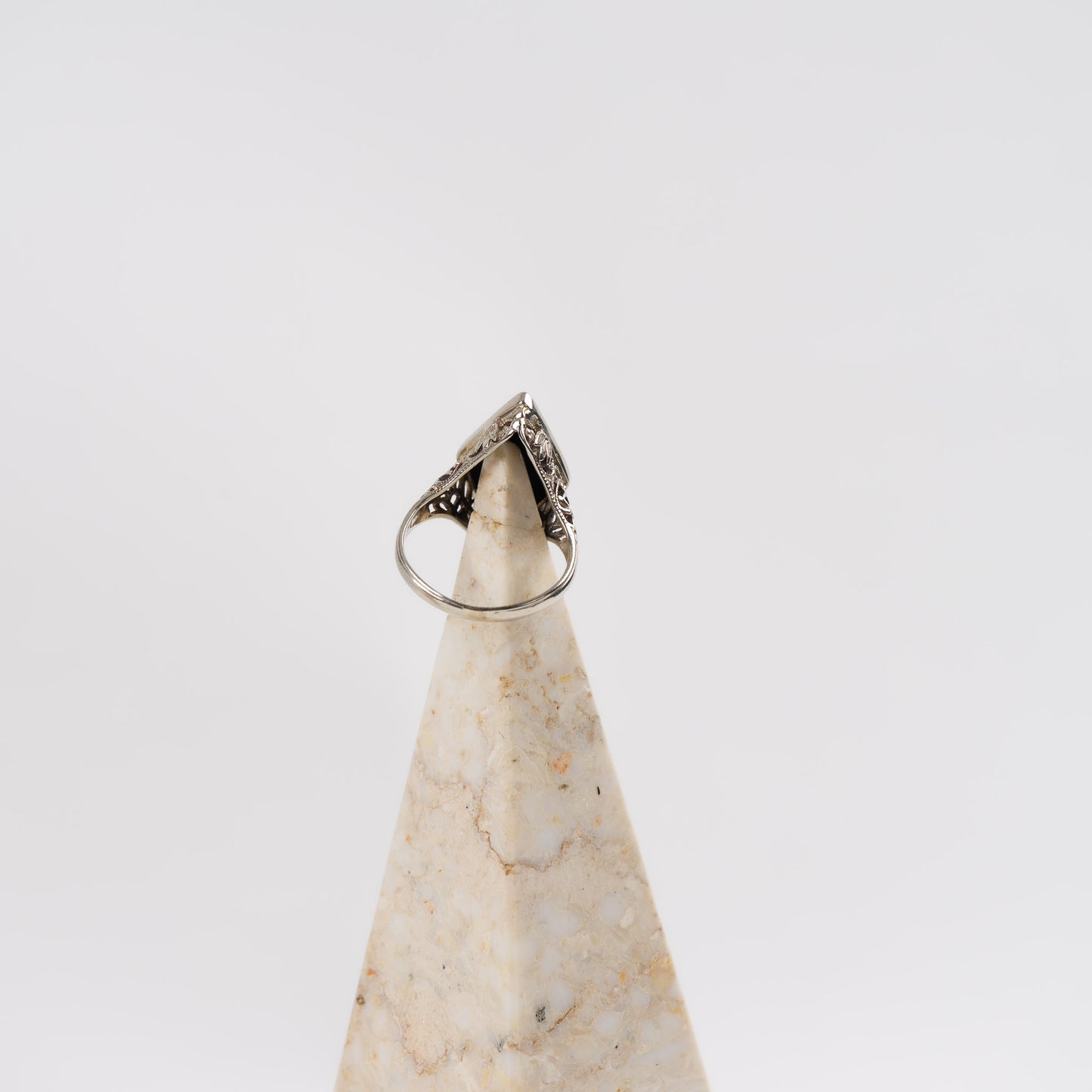 Vintage 14k white gold masonic ring with black onyx stone featuring Eastern Star symbol inlay, showing Art Nouveau decorative details on band sides