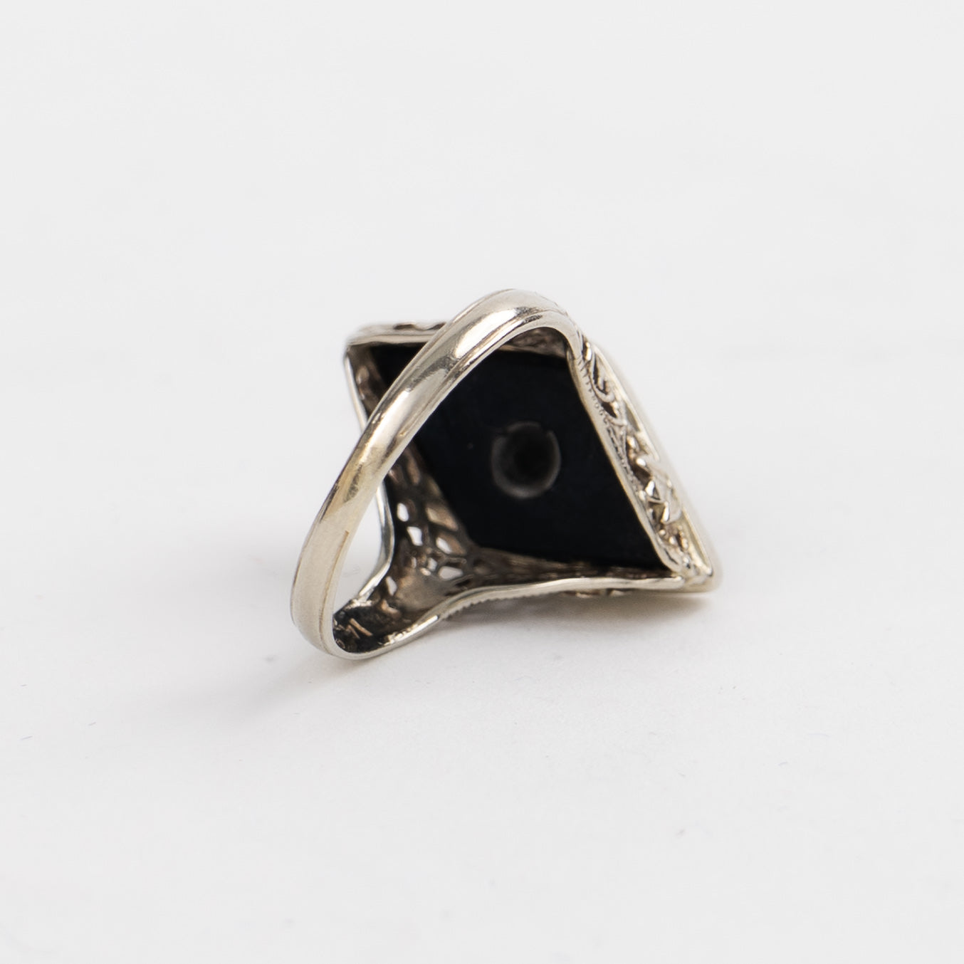 Vintage 14k white gold masonic ring with black onyx stone featuring Eastern Star symbol inlay, showing Art Nouveau decorative details on band sides
