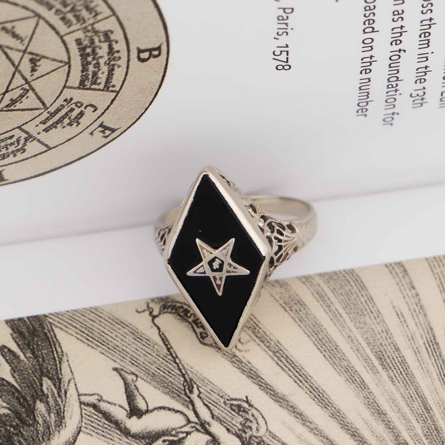 Vintage 14k white gold masonic ring with black onyx stone featuring Eastern Star symbol inlay, showing Art Nouveau decorative details on band sides