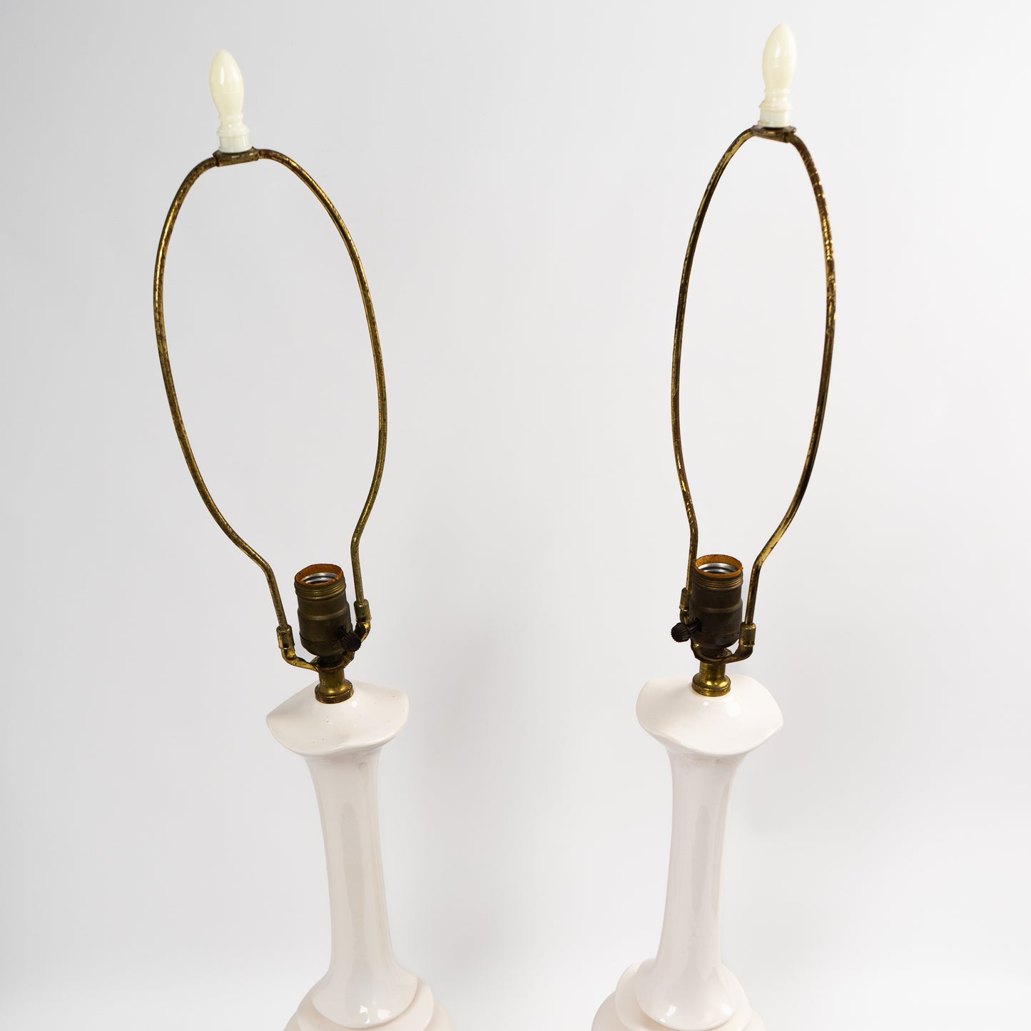 Pair of vintage mid-century off-white ceramic chinoiserie lamp bases with original harps and finials, circa 1950s–1960s.