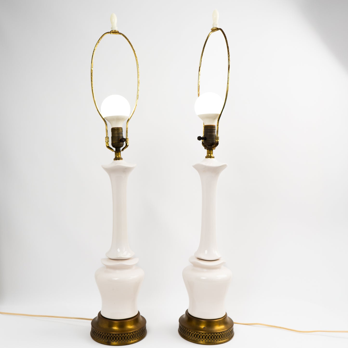 Pair of vintage mid-century off-white ceramic chinoiserie lamp bases with original harps and finials, circa 1950s–1960s.