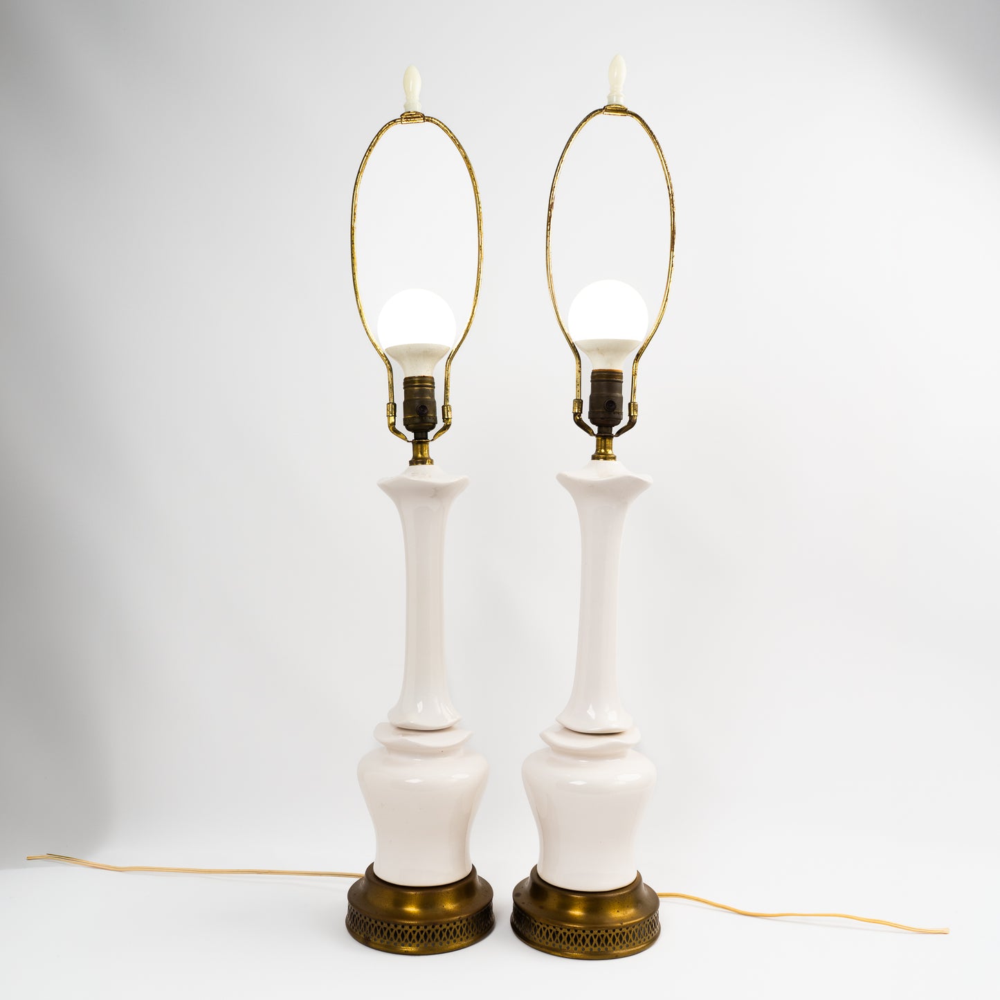 Pair of vintage mid-century off-white ceramic chinoiserie lamp bases with original harps and finials, circa 1950s–1960s.