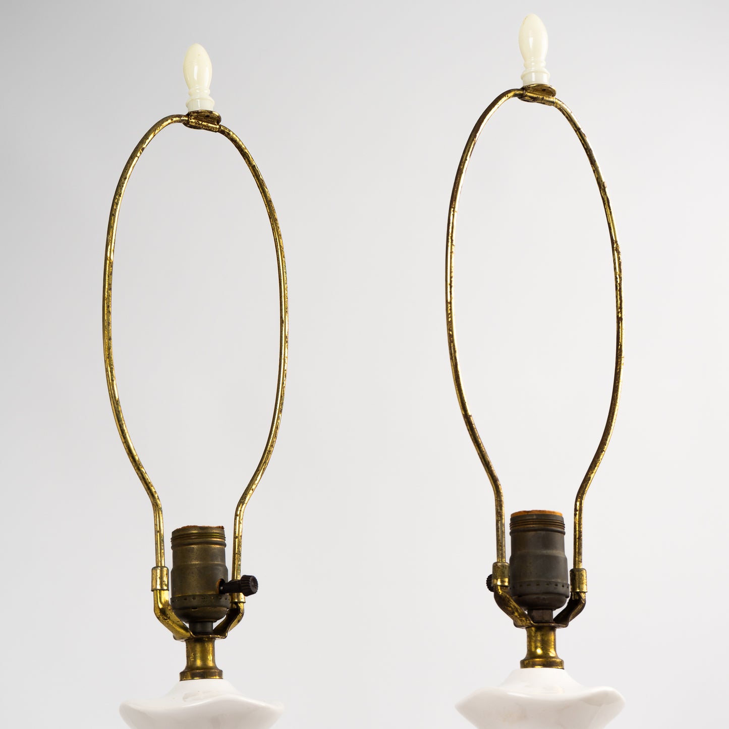 Pair of vintage mid-century off-white ceramic chinoiserie lamp bases with original harps and finials, circa 1950s–1960s.