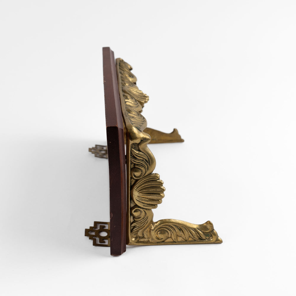 
                  
                    Vintage mid-century modern wall shelf with cherry wood surface, brass supports, and raised edge for displaying art

                  
                