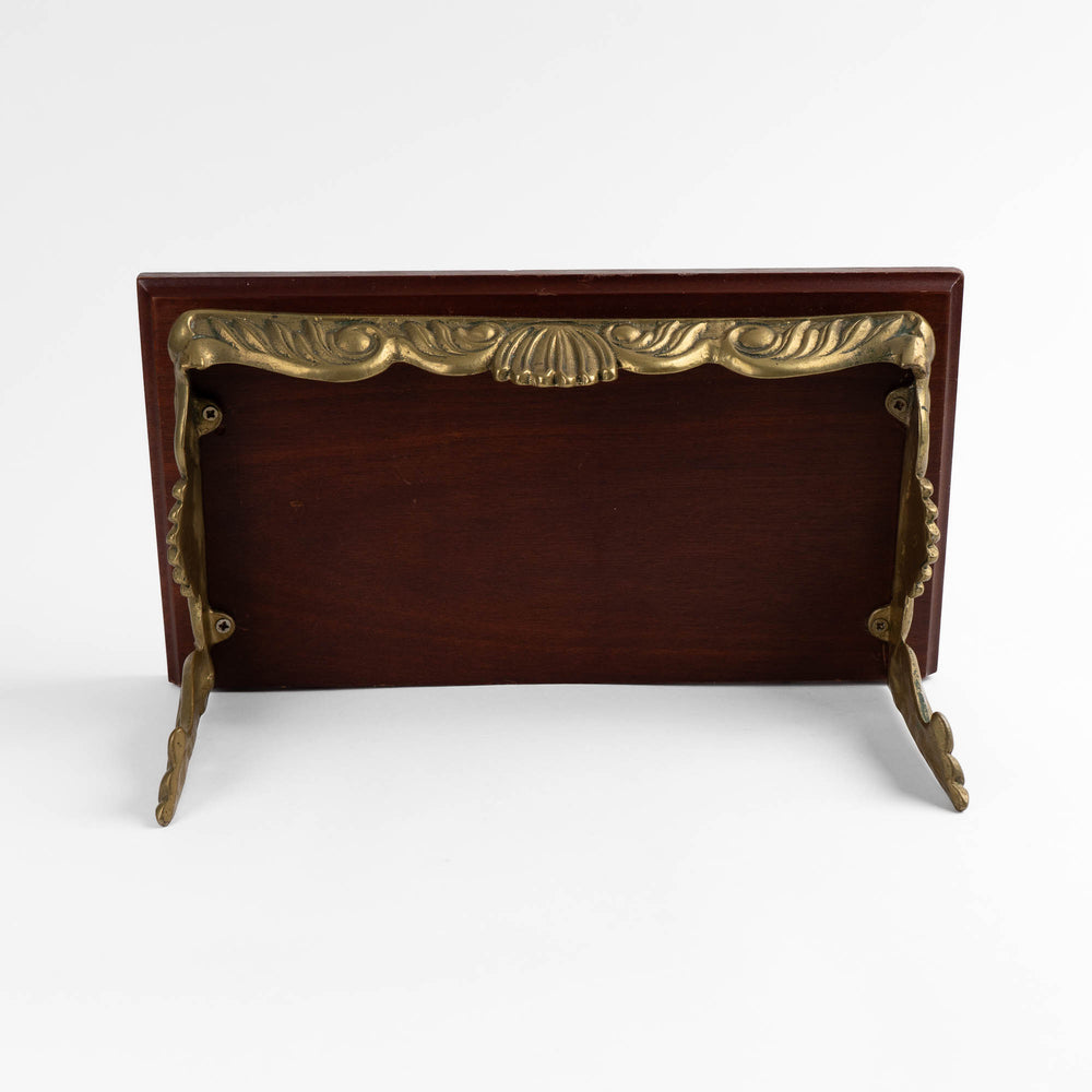 
                  
                    Vintage mid-century modern wall shelf with cherry wood surface, brass supports, and raised edge for displaying art

                  
                