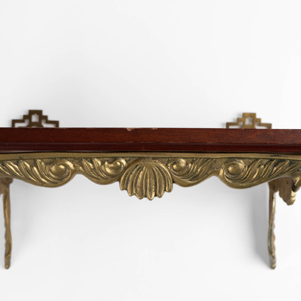 
                  
                    Vintage mid-century modern wall shelf with cherry wood surface, brass supports, and raised edge for displaying art
                  
                