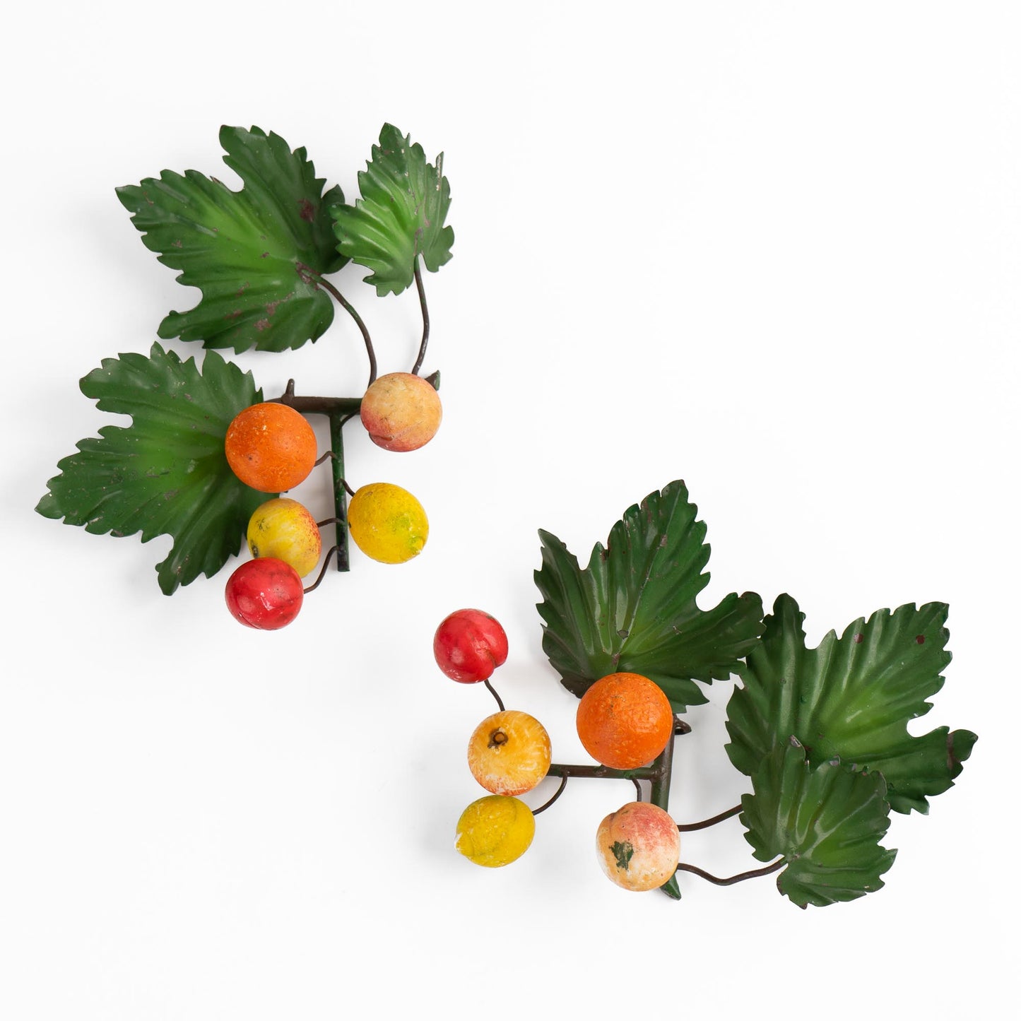 Pair of vintage Italian tole metal wall art with painted citrus fruits and green leaves in orange, yellow, red, and green colors
