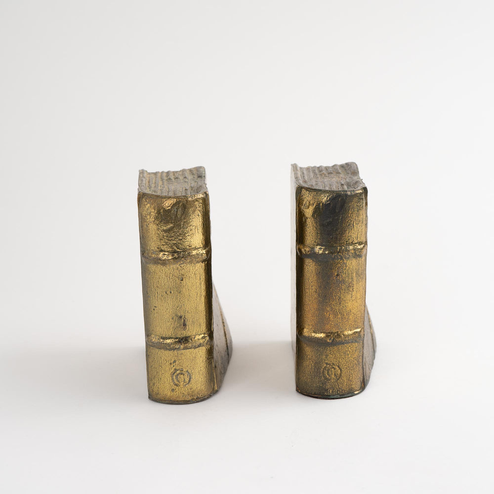 
                  
                    Pair of vintage brass bookends shaped like books
                  
                