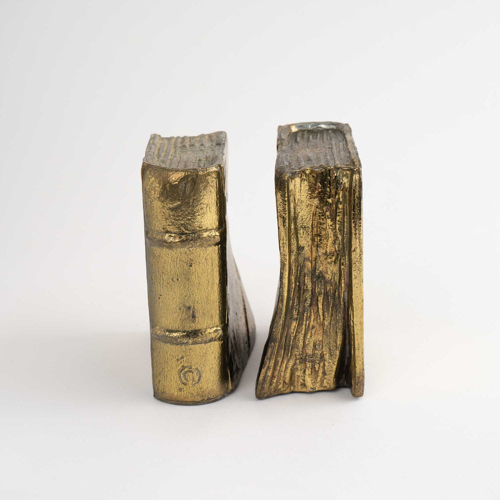 
                  
                    Pair of vintage brass bookends shaped like books
                  
                
