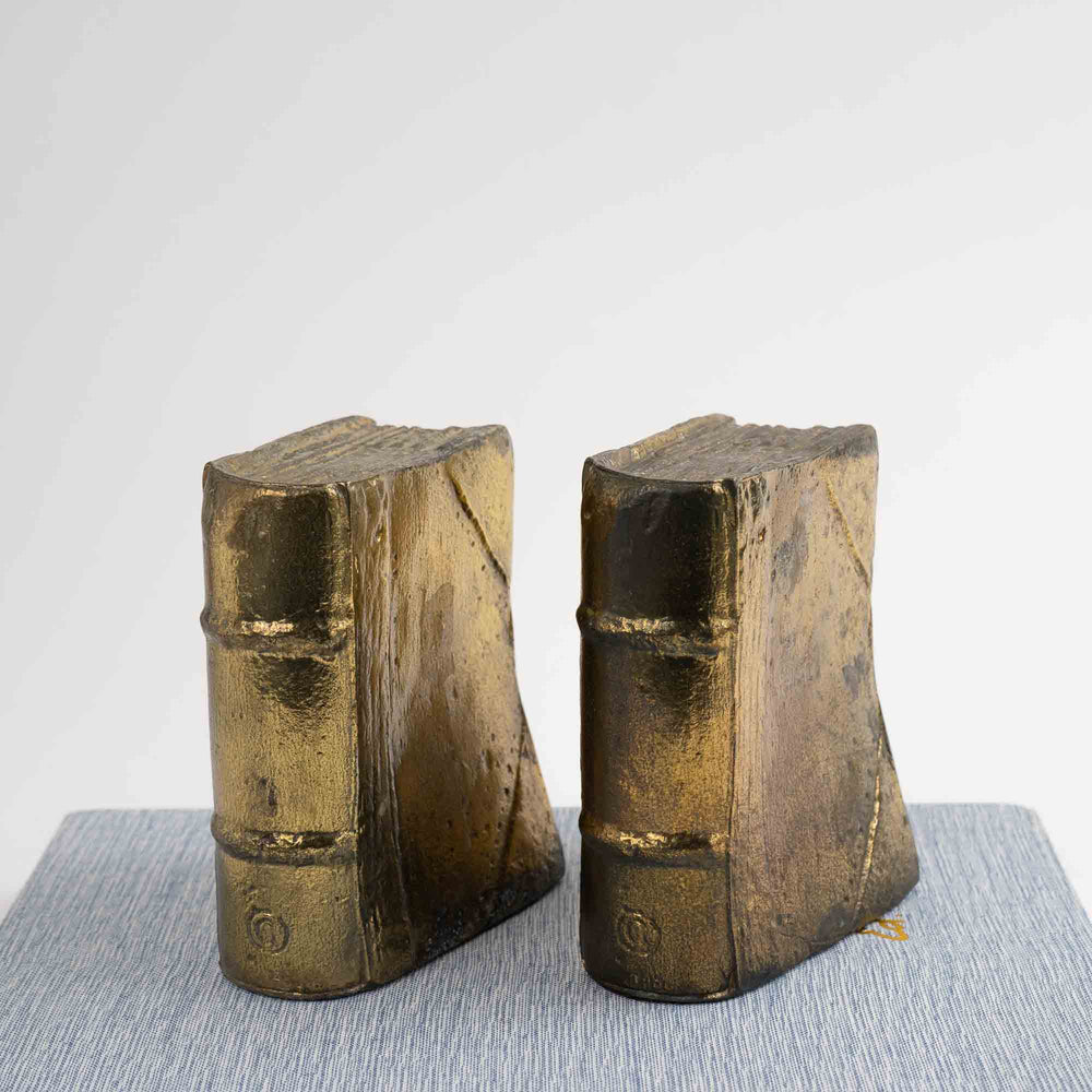 
                  
                    Pair of vintage brass bookends shaped like books
                  
                