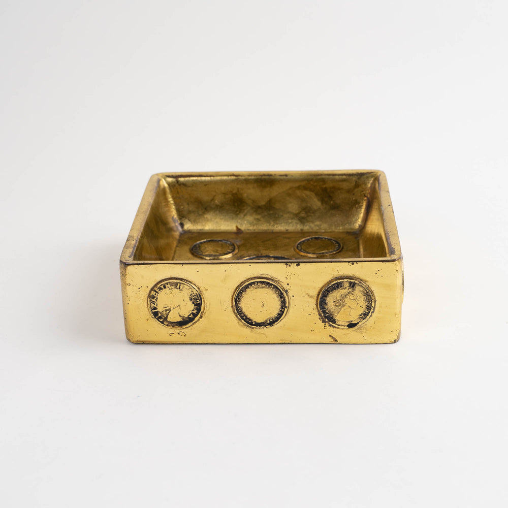 
                  
                    Vintage square brass ashtray featuring decorative historic Napoleon and Elizabeth coins
                  
                