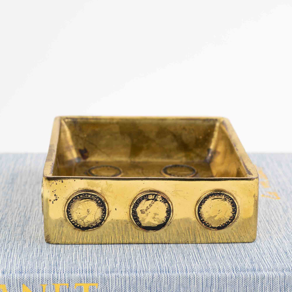 
                  
                    Mid-century square brass ashtray featuring decorative historic Napoleon and Elizabeth coins
                  
                