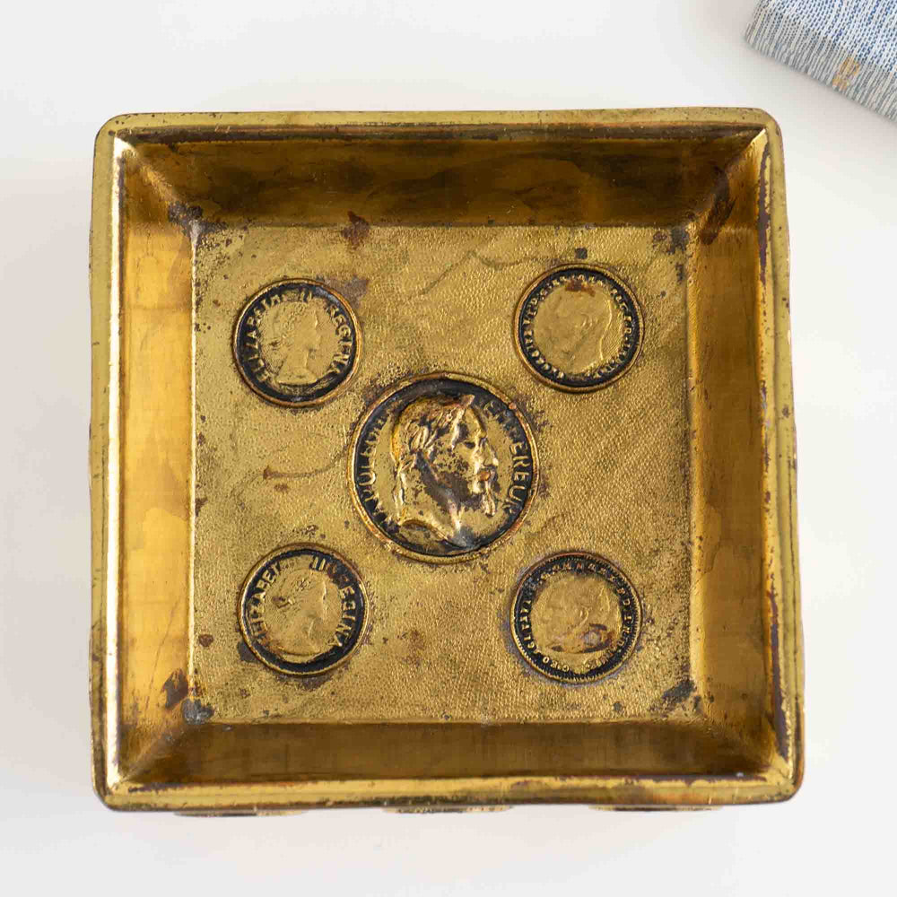 
                  
                    Mid-century square brass ashtray featuring decorative historic Napoleon and Elizabeth coins
                  
                