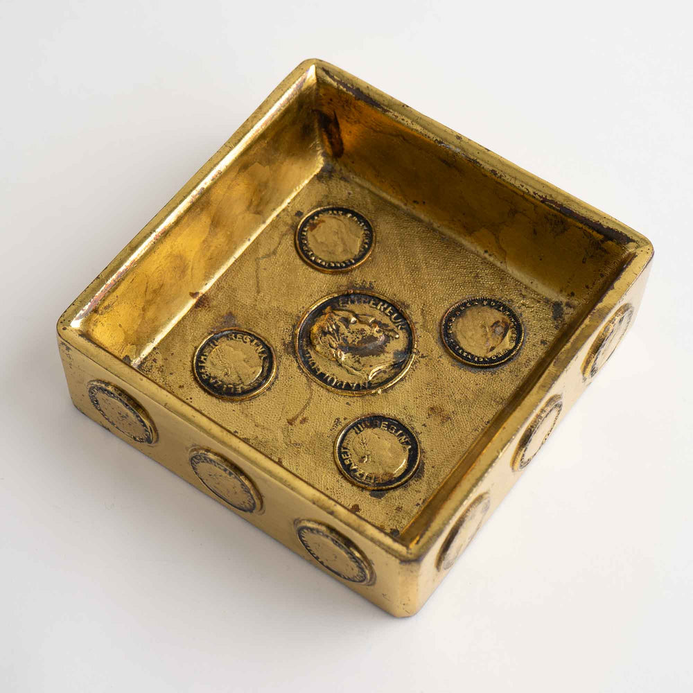 
                  
                    Mid-century square brass ashtray featuring decorative historic Napoleon and Elizabeth coins 
                  
                