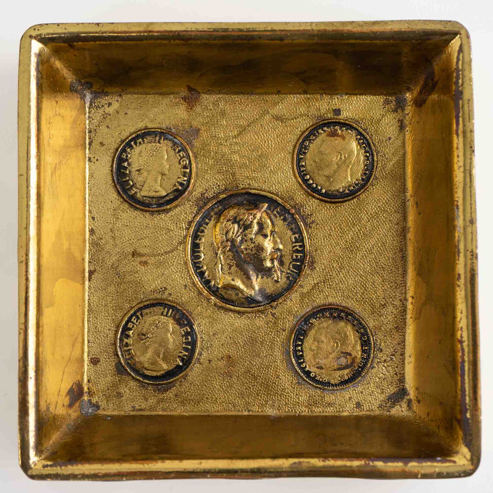 
                  
                    Vintage square brass ashtray featuring decorative historic Napoleon and Elizabeth coins
                  
                