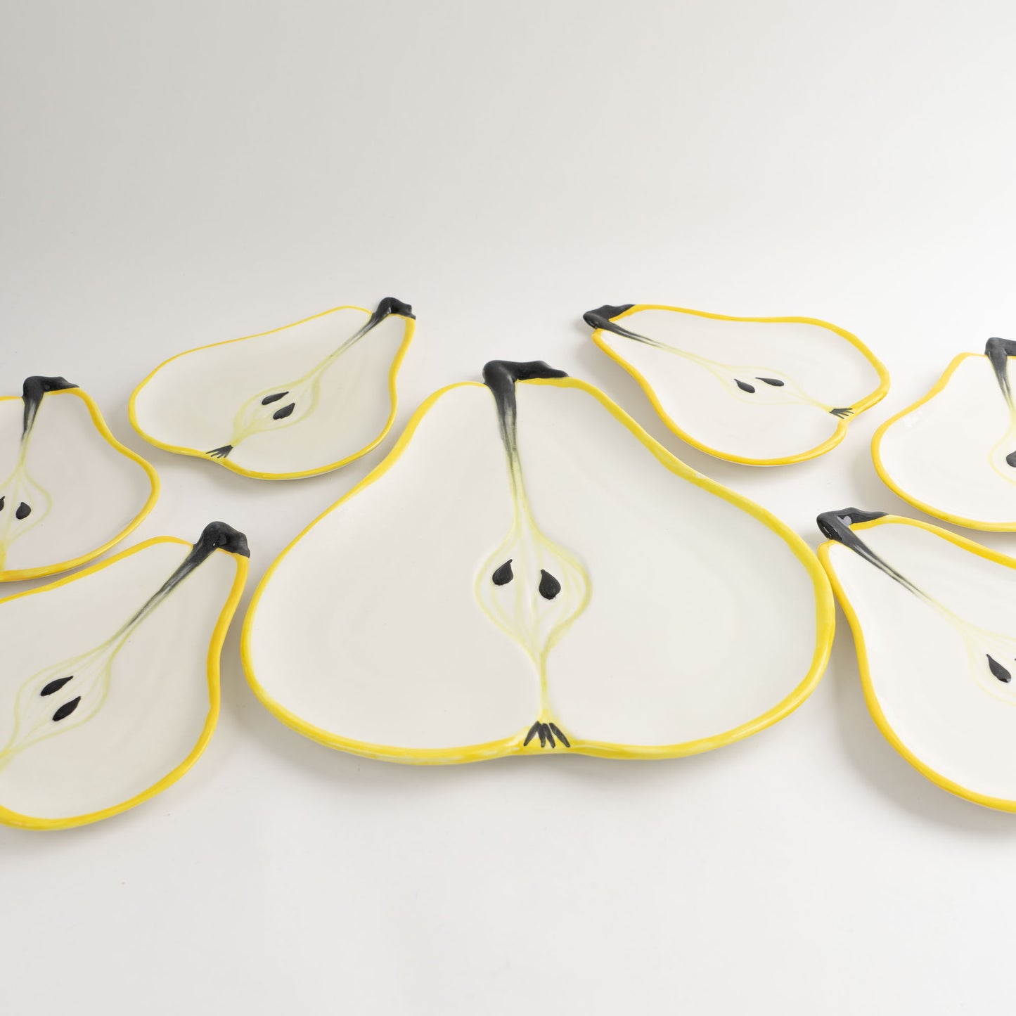 Set of seven vintage hand-painted pear-shaped ceramic plates designed by Ernestine Cannon and made in Salerno, Italy