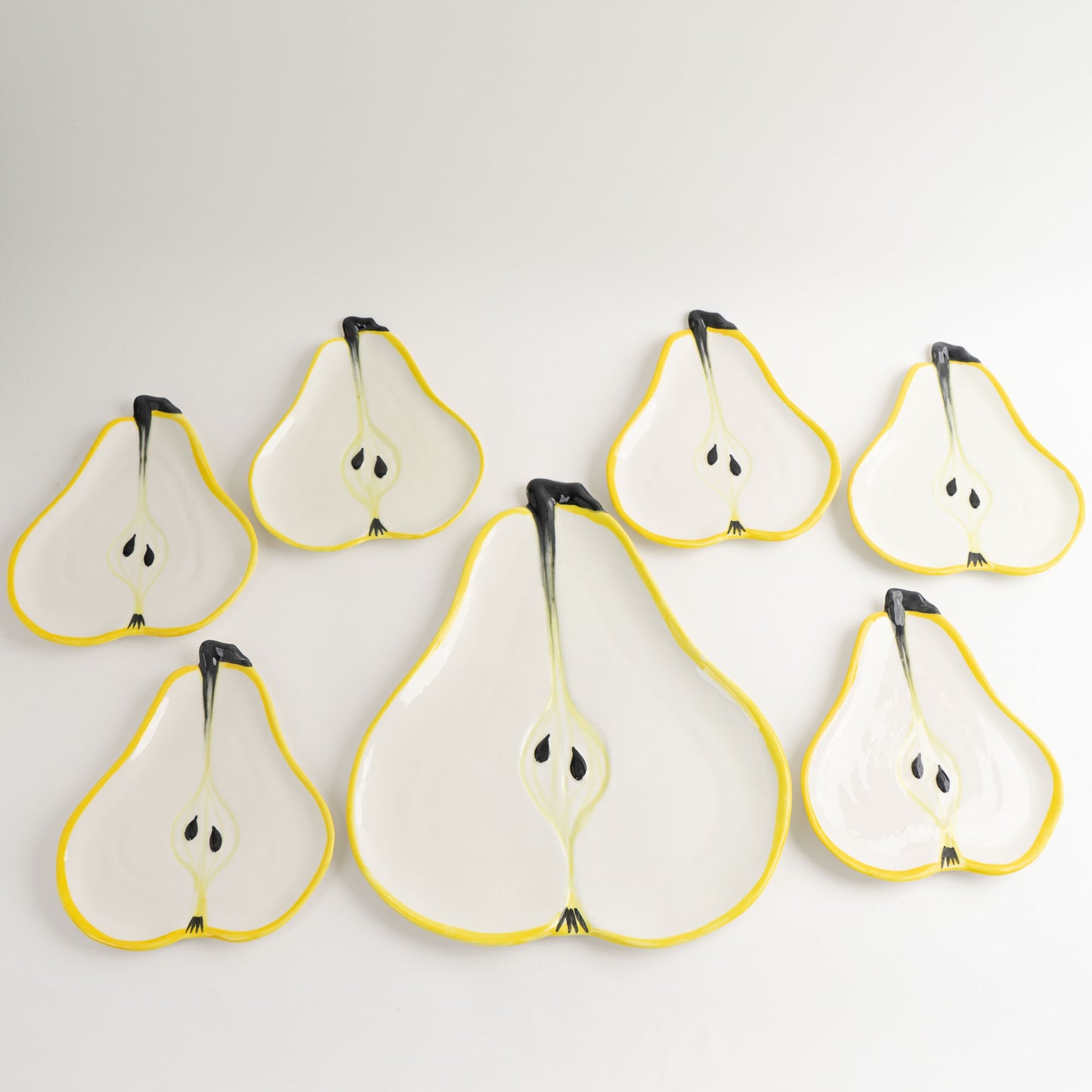 Set of seven vintage hand-painted pear-shaped ceramic plates designed by Ernestine Cannon and made in Salerno, Italy