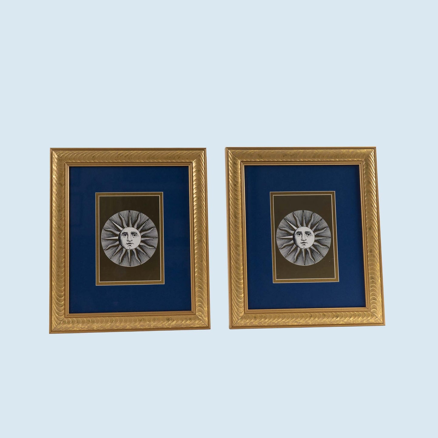 Pair of vintage Fornasetti Soli (sun) prints in gold frames with blue matting and metallic gold sun details