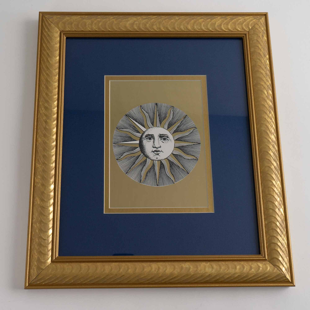 
                  
                    vintage Fornasetti Soli (sun) prints in gold frames with blue matting and metallic gold sun details
                  
                