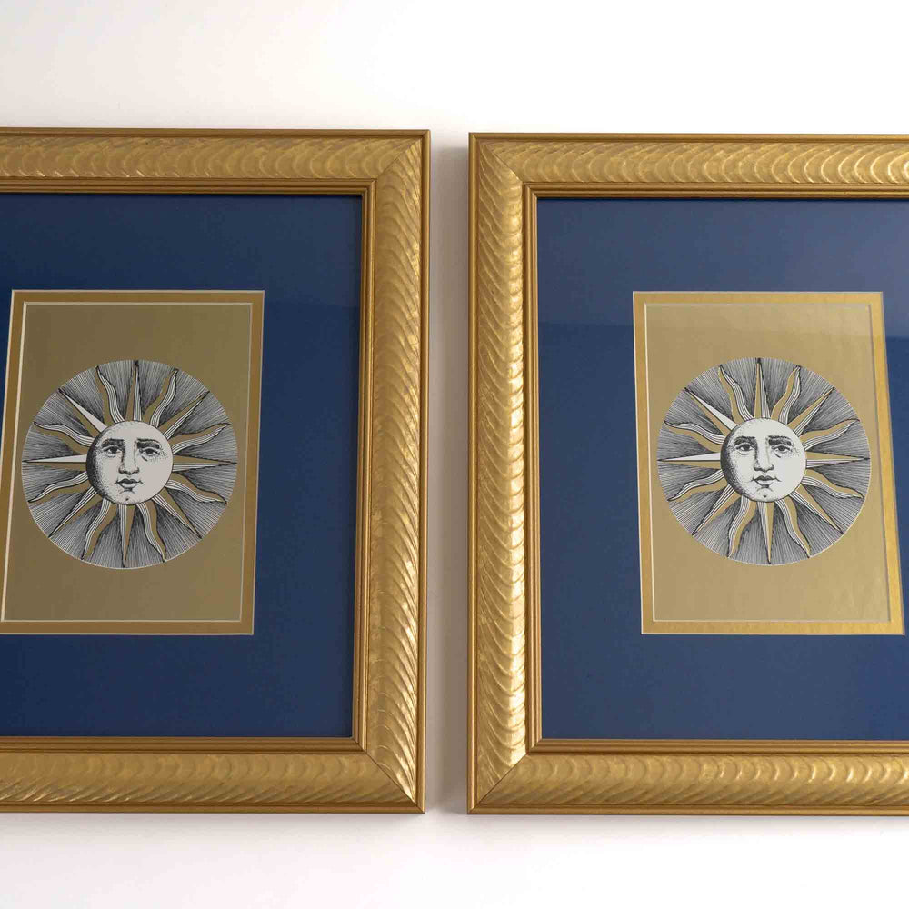 
                  
                    Pair of vintage Fornasetti Soli (sun) prints in gold frames with blue matting and metallic gold sun details
                  
                