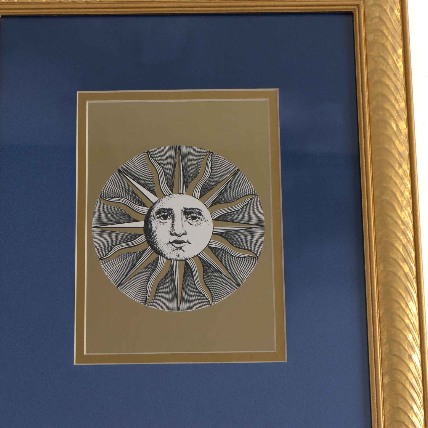 Pair of vintage Fornasetti Soli (sun) prints in gold frames with blue matting and metallic gold sun details