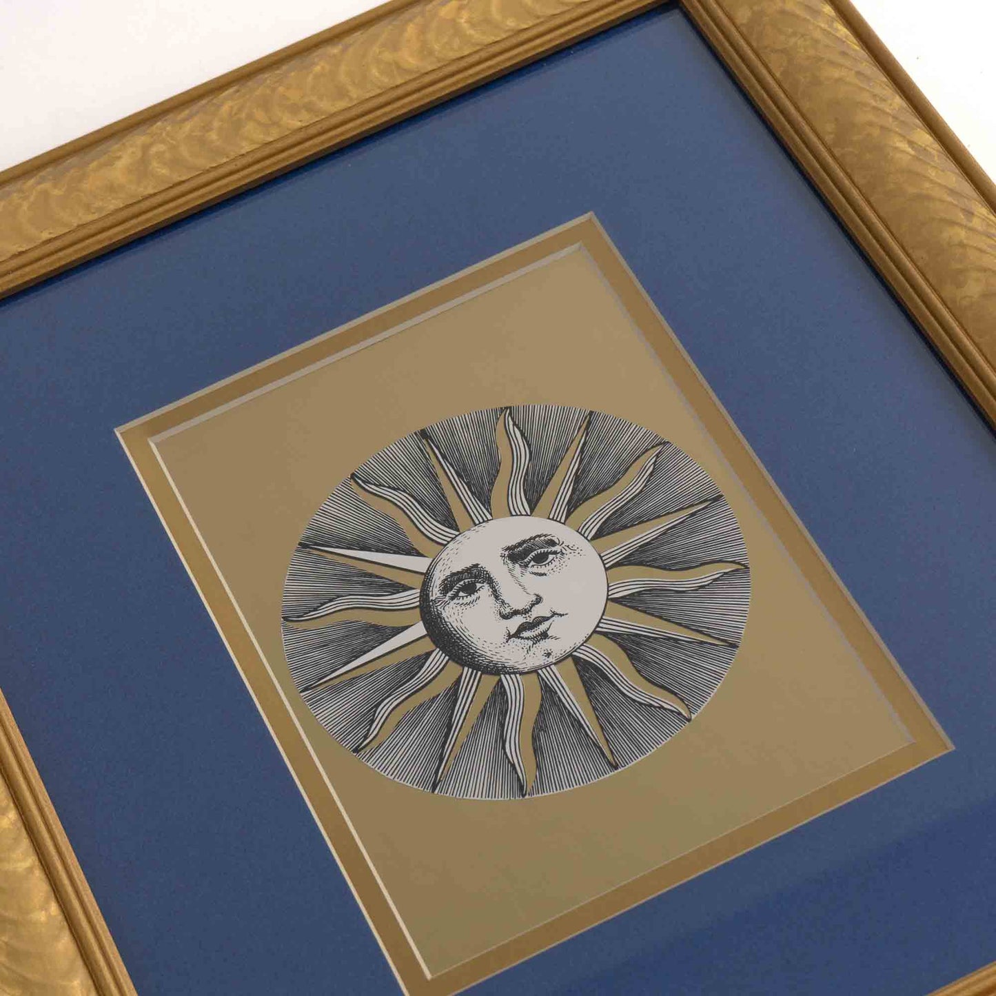 Vintage Fornasetti Soli Celestial (sun) prints in gold frames with blue matting and metallic gold sun details