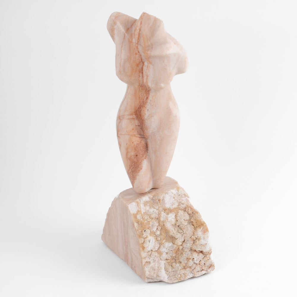 
                  
                    Hand-carved pink alabaster nude female torso sculpture by American artist Bryan Ross, signed, with base, 20th century.
                  
                