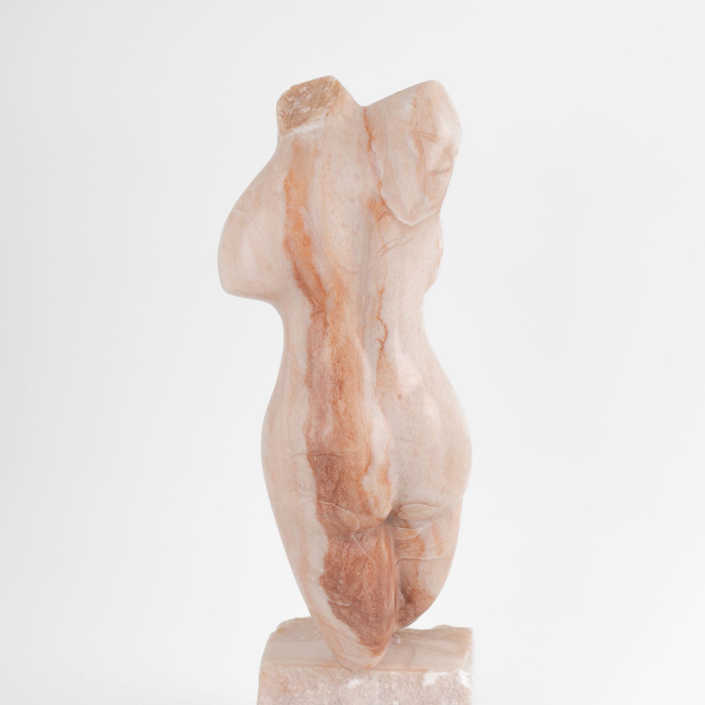 Hand-carved pink alabaster nude female torso sculpture by American artist Bryan Ross, signed, with base, 20th century.