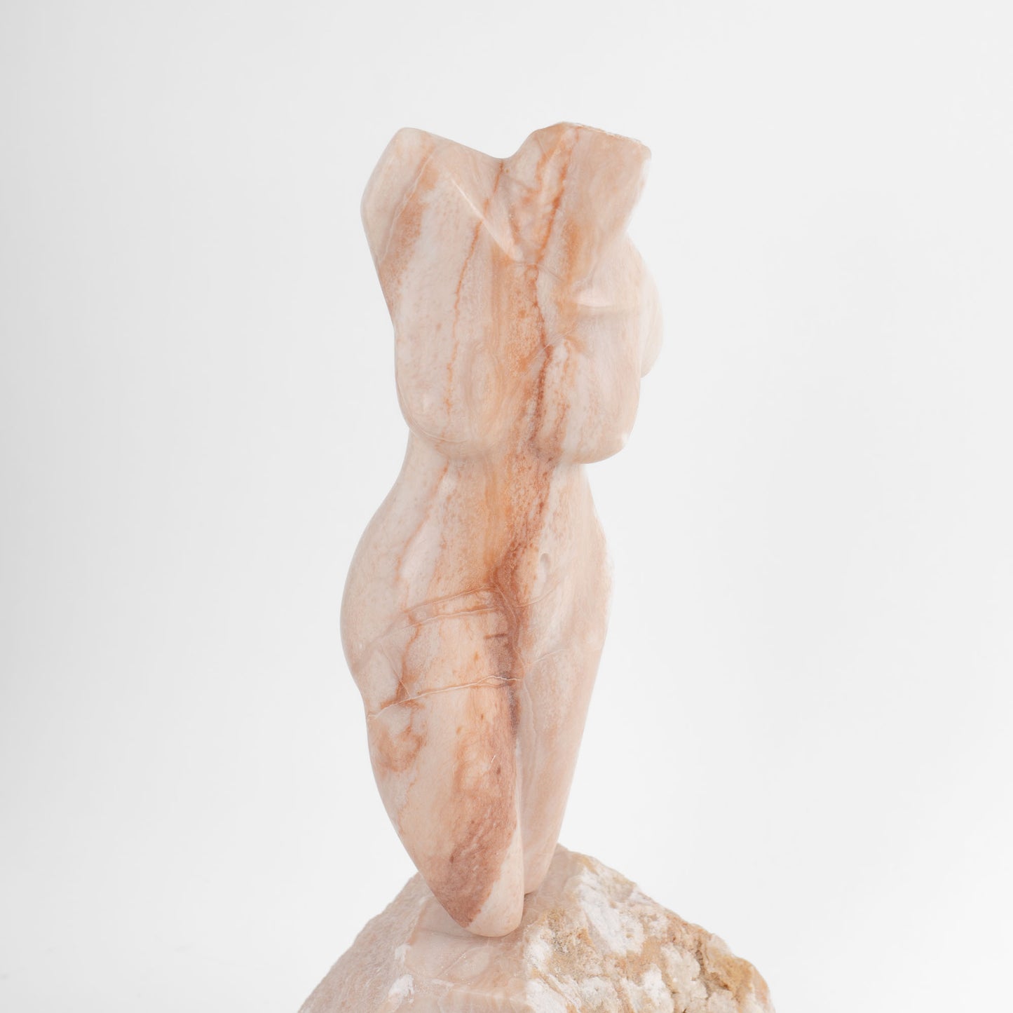 Hand-carved pink alabaster nude female torso sculpture by American artist Bryan Ross, signed, with base, 20th century.