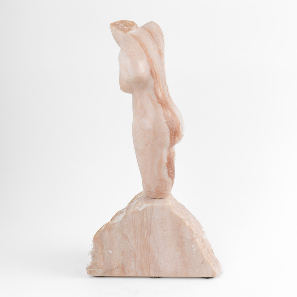 
                  
                    Hand-carved pink alabaster nude female torso sculpture by American artist Bryan Ross, signed, with base, 20th century.
                  
                