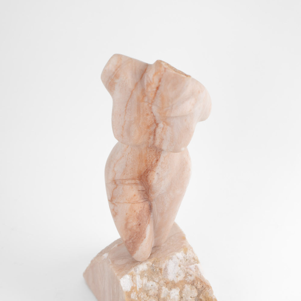 
                  
                    Hand-carved pink alabaster nude female torso sculpture by American artist Bryan Ross, signed, with base, 20th century.
                  
                